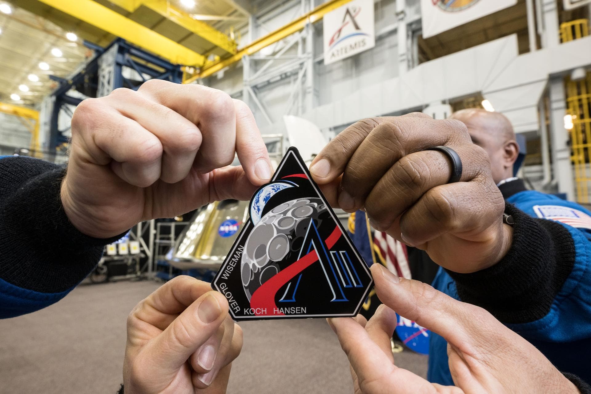 Artemis II Crew Holds Mission Patch